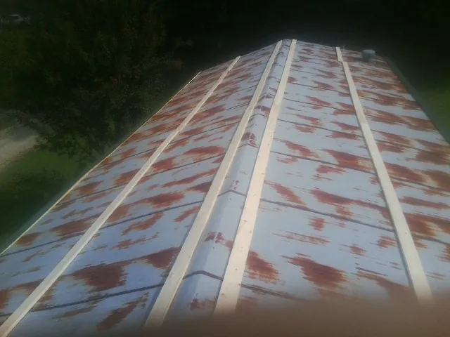 Rusted metal roof panels with new wood purlins before replacement — Storm Damage Roof Repair in Cookstown by Roofing Brothers
