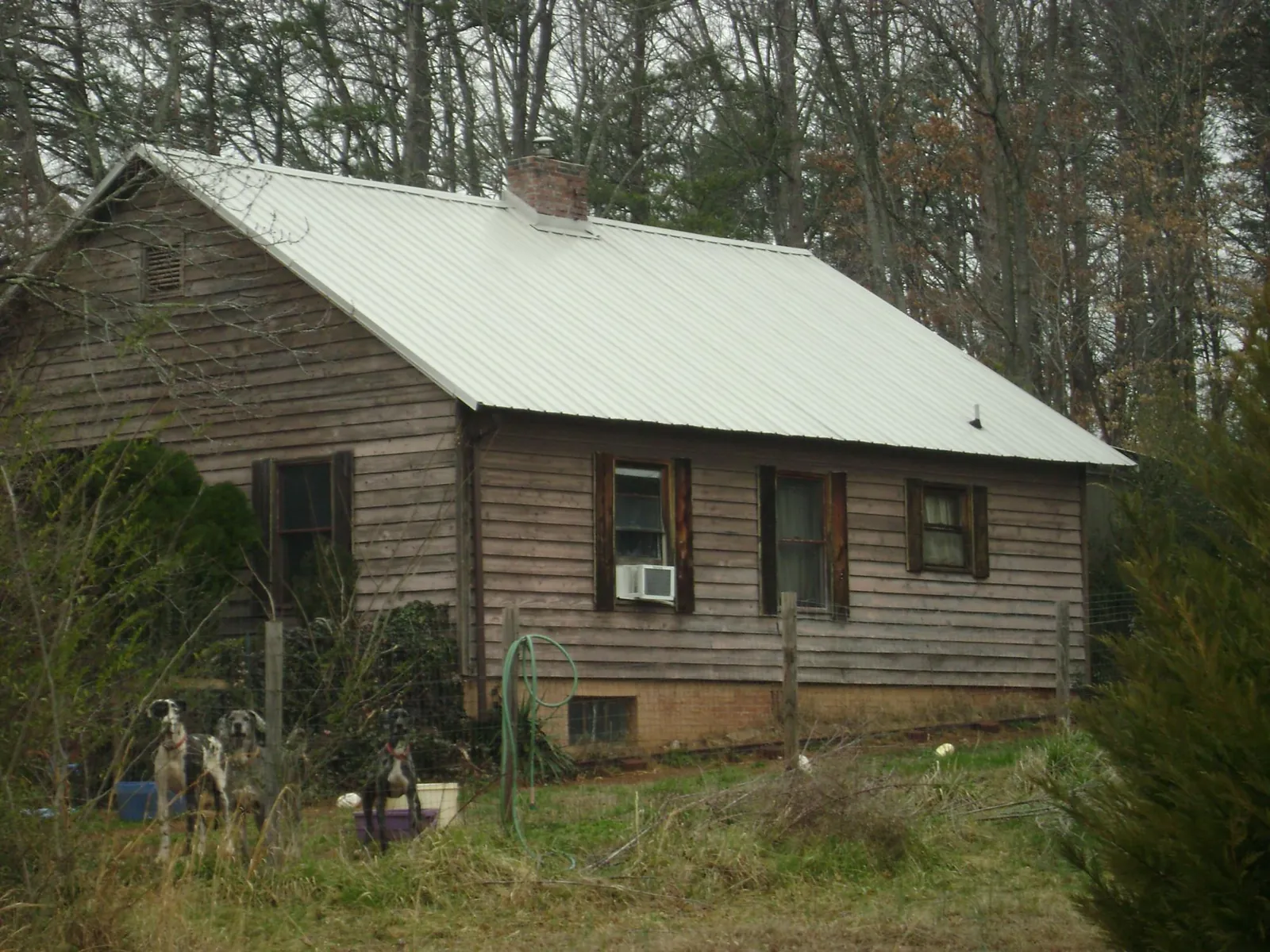 White metal roof on an old wood sided farmhouse, from a Metal Roof Installation job in Cookstown
